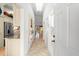 Bright hallway with tile flooring, decorative mirror, and access to various rooms at 1211 Spoonbill Landings Cir, Bradenton, FL 34209