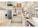 Bright kitchen featuring granite countertops, stainless steel appliances, and custom cabinetry at 1211 Spoonbill Landings Cir, Bradenton, FL 34209