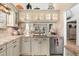 Kitchen area with granite countertops, stainless steel dishwasher, and decorative elements at 1211 Spoonbill Landings Cir, Bradenton, FL 34209
