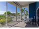 Relaxing screened patio with seating, views of the landscape, and a glimpse of the pool at 1211 Spoonbill Landings Cir, Bradenton, FL 34209
