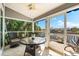Screened patio with ceiling fan, outdoor seating, and waterfront view at 1211 Spoonbill Landings Cir, Bradenton, FL 34209