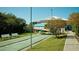 Enjoy the community's recreational facilities at the shuffleboard courts with benches and lush green landscaping at 1211 Spoonbill Landings Cir, Bradenton, FL 34209