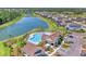 Community pool and amenity center with a resort-style pool, sun loungers and a lake at 13013 Oak Hill Way, Parrish, FL 34219