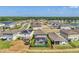 Aerial view of a residential neighborhood featuring single-Gathering homes, a lake, and private pools at 13013 Oak Hill Way, Parrish, FL 34219
