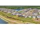 Aerial view of houses near a lake with green space surrounding the homes in a residential community at 13013 Oak Hill Way, Parrish, FL 34219