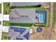 Aerial view of a home with a screened-in pool, solar panels, and well-maintained landscaping at 13013 Oak Hill Way, Parrish, FL 34219