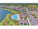 Aerial view of community pool and amenity center with lake views and nearby homes at 13013 Oak Hill Way, Parrish, FL 34219