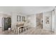 Well-lit dining room with wood-look floors, dining table, and modern decor at 13013 Oak Hill Way, Parrish, FL 34219