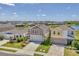 Attractive view of a group of well-maintained, colorful, modern houses with garages on a street at 13013 Oak Hill Way, Parrish, FL 34219