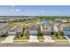 A view of modern homes with manicured lawns in a community near a lake, complete with sidewalks at 13013 Oak Hill Way, Parrish, FL 34219