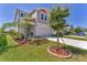 Well-manicured front lawn with landscaping leading up to a modern home with a two-car garage at 13013 Oak Hill Way, Parrish, FL 34219