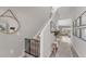 Hallway with stairs, wood-look flooring, and view into living area, and modern decor at 13013 Oak Hill Way, Parrish, FL 34219