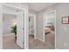 Hallway view leading to bedrooms and bathroom with natural light and neutral color palette at 13013 Oak Hill Way, Parrish, FL 34219