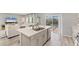 Modern kitchen featuring a kitchen island, stainless steel appliances, and a seamless flow to the living area at 13013 Oak Hill Way, Parrish, FL 34219