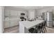 Bright kitchen boasts stainless appliances, gray cabinets, and a large island with bar seating at 13013 Oak Hill Way, Parrish, FL 34219