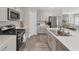 Well-lit modern kitchen featuring stainless steel appliances and gray cabinets with lots of storage at 13013 Oak Hill Way, Parrish, FL 34219