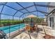 Relaxing screened-in pool area featuring a dining table and plenty of seating at 13013 Oak Hill Way, Parrish, FL 34219