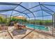 Enjoy the screened-in pool with outdoor dining area, perfect for relaxation and entertainment at 13013 Oak Hill Way, Parrish, FL 34219