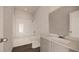 Bright bathroom featuring a shower-tub combo, wood-look flooring, and a gray vanity with a white countertop at 13104 Bayberry Way, Parrish, FL 34219
