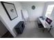 Bright home office with minimalist desk, rolling chair, and black storage cabinet at 13104 Bayberry Way, Parrish, FL 34219
