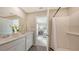 Bright bathroom with double vanity sinks, white cabinetry, and a separate shower at 13108 Bayberry Way, Parrish, FL 34219