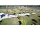 An aerial view of a well-maintained community park with a lake, walking paths, and shady picnic areas at 13108 Bayberry Way, Parrish, FL 34219
