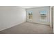 Empty bedroom with neutral carpet, two windows and white walls at 13116 Bayberry Way, Parrish, FL 34219
