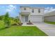 Beautiful two-story home featuring a blue front door, two-car garage, and green lawn at 13116 Bayberry Way, Parrish, FL 34219