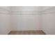 Spacious empty walk-in closet with wall-mounted wire shelving and neutral carpet at 13116 Bayberry Way, Parrish, FL 34219