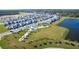 Aerial view of a Primary-planned community with houses, parks, and a lake at 13124 Bayberry Way, Parrish, FL 34219