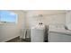 Functional laundry room equipped with modern washer and dryer, shelving, and ample natural light at 13124 Bayberry Way, Parrish, FL 34219