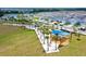 An aerial view shows the park area with a playground and palm-lined pathways at 13132 Bayberry Way, Parrish, FL 34219