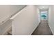 Bright hallway with wood-look floors leading to an open living space, featuring a staircase on the left at 13132 Bayberry Way, Parrish, FL 34219