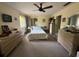 Bedroom with a ceiling fan, multiple windows, and neutral decor at 13406 Leatherbury Ave, Port Charlotte, FL 33953