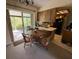 Dining area near kitchen features sliding door to the screened patio at 13406 Leatherbury Ave, Port Charlotte, FL 33953