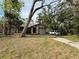 Charming single-story home with mature trees and a well-manicured lawn at 13406 Leatherbury Ave, Port Charlotte, FL 33953