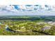 Wide aerial view of the neighborhood surrounded by waterways and greenery at 14921 Barrows Bluff Ter, Bradenton, FL 34212