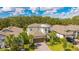 An elevated view captures the house's manicured lawn, two car garage, and proximity to neighboring houses and large trees at 14921 Barrows Bluff Ter, Bradenton, FL 34212