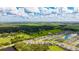 Beautiful aerial view of the neighborhood near a lush green field and lake at 14921 Barrows Bluff Ter, Bradenton, FL 34212