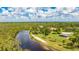 Stunning aerial view of the property featuring a river, sandy beach, and outdoor picnic area at 14921 Barrows Bluff Ter, Bradenton, FL 34212