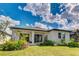 Beautiful backyard with manicured lawn, covered patio, and lush landscaping, perfect for outdoor living at 14921 Barrows Bluff Ter, Bradenton, FL 34212