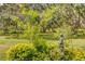Beautifully landscaped backyard area featuring lush greenery and a charming statue at 14921 Barrows Bluff Ter, Bradenton, FL 34212