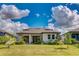 Spacious backyard featuring a well-maintained lawn, covered patio, and lovely landscaping at 14921 Barrows Bluff Ter, Bradenton, FL 34212