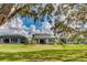 Large backyard with a manicured lawn and an oversized covered patio at 14921 Barrows Bluff Ter, Bradenton, FL 34212
