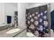 Bathroom featuring granite counters, a vanity, and a floral shower curtain at 14921 Barrows Bluff Ter, Bradenton, FL 34212