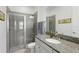 Modern bathroom with granite counters, glass-enclosed shower, and neutral color palette at 14921 Barrows Bluff Ter, Bradenton, FL 34212