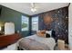Stylish bedroom with unique wallpaper, a ceiling fan, and a cozy bed at 14921 Barrows Bluff Ter, Bradenton, FL 34212