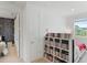 Bright bedroom with DVDs on shelving and a view through the window at 14921 Barrows Bluff Ter, Bradenton, FL 34212