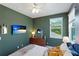 A bedroom with interesting wall color, a TV, and a great view through the window at 14921 Barrows Bluff Ter, Bradenton, FL 34212