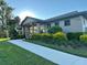 Inviting clubhouse exterior featuring a covered entry, manicured landscaping, and well-maintained walkway at 14921 Barrows Bluff Ter, Bradenton, FL 34212